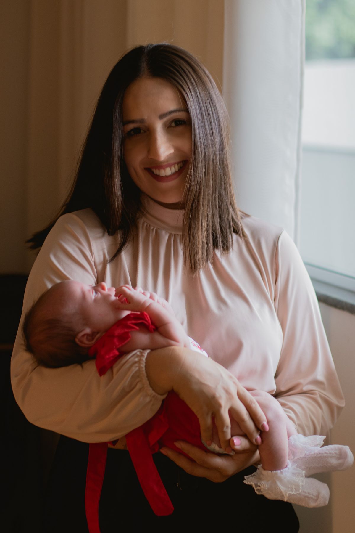 Mother gently holding her newborn baby